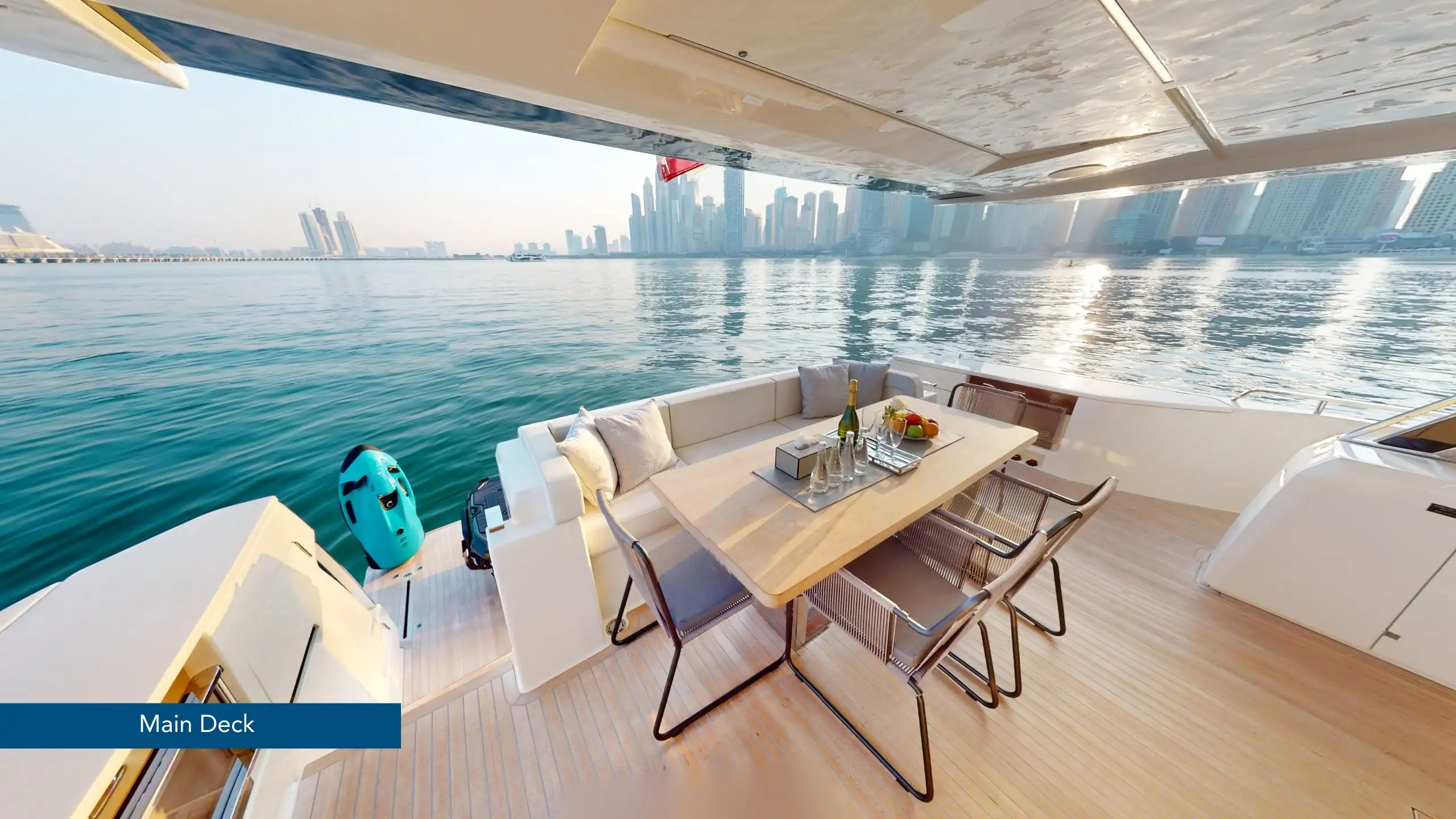Spacious deck of a Dubai yacht rental with lounge seating and sea view